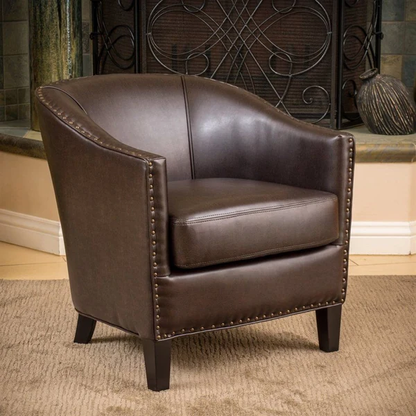 Dark brown leather barrel chair with nailhead trim
