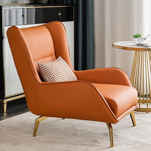 Orange leather wingback chair with gold legs