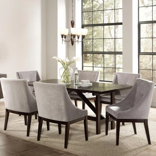 Sleek dark wood table with velvet grey chairs