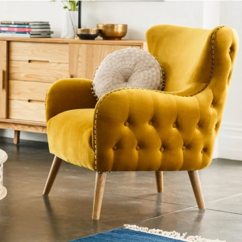 Yellow velvet tufted wingback armchair