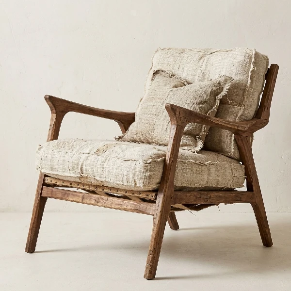 Rustic wood armchair with raw-edge burlap cushions.
